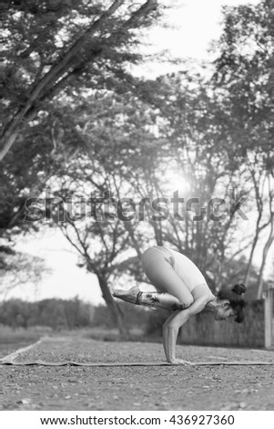 Yoga for Health And to better shape . This image is a black and white portrait .