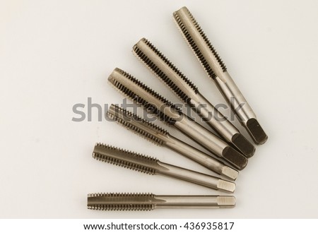 Hand tap (threading tool) on white background.