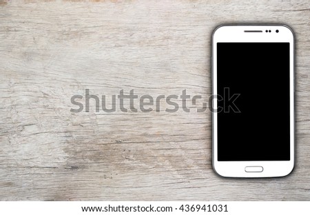 Smartphone on wood background with copy space and text space 