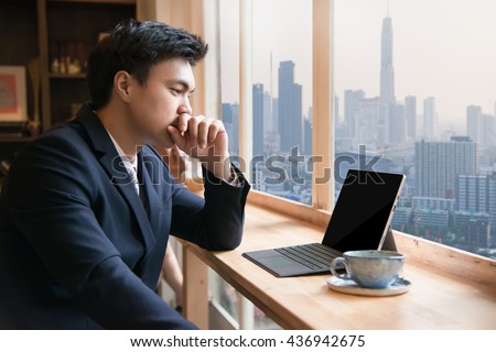 Business man with tablet computer at coffee shop Royalty-Free Stock Photo #436942675