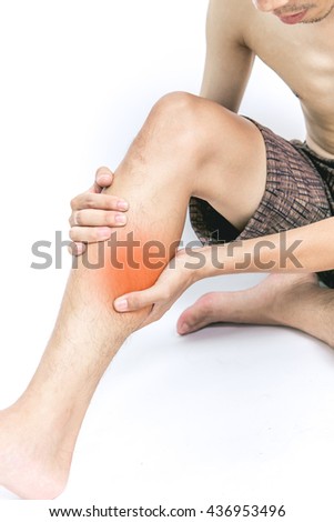 Young man holding his calf muscle in pain, isolated on white background