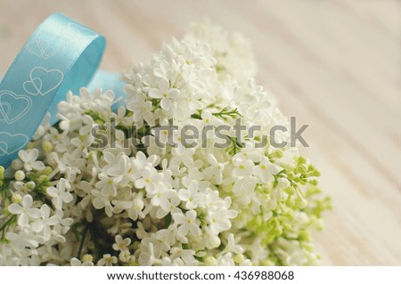 Spring romantic bouquet of a white lilac. Beautiful flowers of a lilac on a textural wooden surface