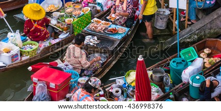 Colorful trader's boats in a floating market in Thailand. Floating markets are one of the main cultural tourist destinations in Asia. Royalty-Free Stock Photo #436998376