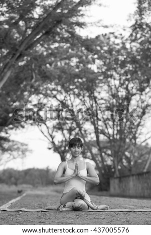 Yoga for Health And to better shape . This image is a black and white portrait .