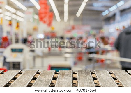 Shelves with goods in a supermarket. Blur and defocus image as a background and designs postcard, menus, catalogs.