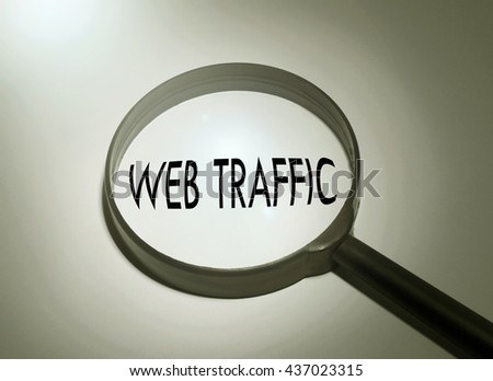 Magnifying glass with the word web traffic. Searching web traffic