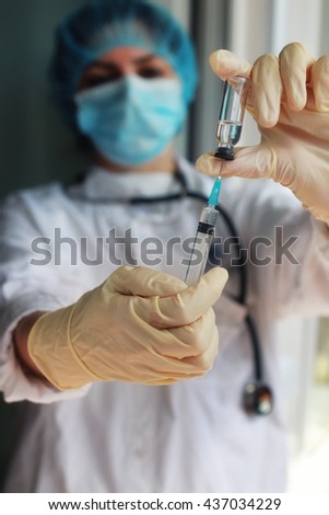 nurse hands holding syringe and ampoule