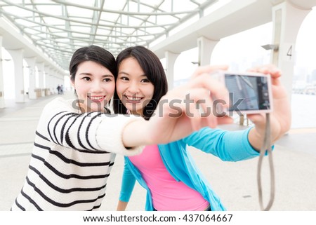Woman taking photo with camera together