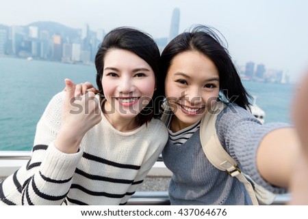 Woman taking selfie image together