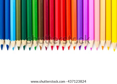 Colored pencils lined in row, isolated on white background. Top view.