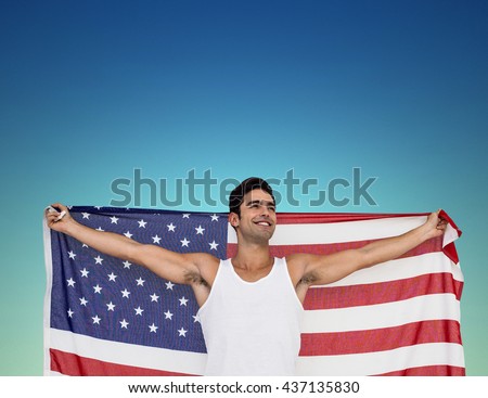 Athlete posing with american flag after victory against dark blue green background