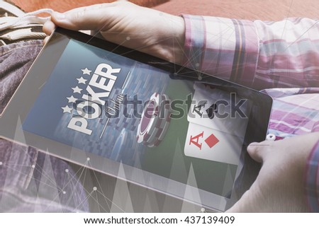 close-up view of man holding a tablet showing poker online website. All screen graphics are made up.