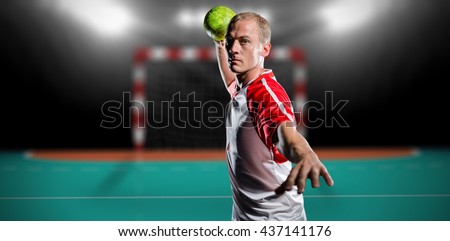 Sportsman throwing a ball against handball field indoor