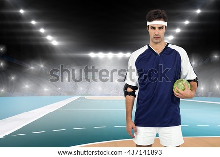 Sportsman standing with ball on white background against handball field indoor