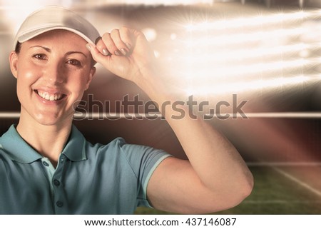 Sportswoman posing on black background against digitally generated image of tennis court and spotlight