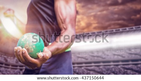 Focus on man holding hammer against composite image of stadium