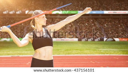 Front view of sportswoman practising javelin throw against view of a stadium Royalty-Free Stock Photo #437156101