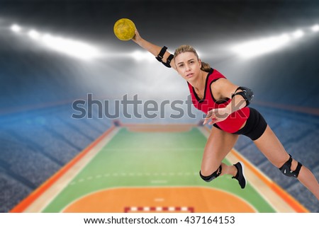 Female athlete throwing handball against handball field indoor
