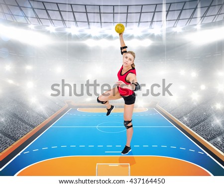 Female athlete throwing handball against handball field indoor
