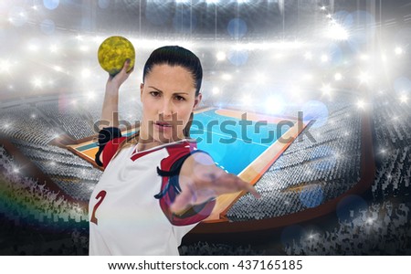 Sportswoman throwing a ball against handball field indoor