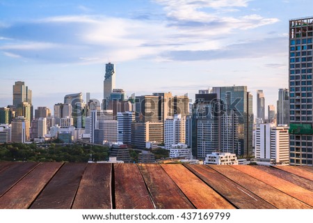 Bangkok in the evening wooden floor , Panoramic and perspective view light blue background  building skyscraper commercial of future. Business concept of success industry tech architecture,pastel tone