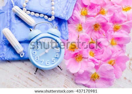 Woman hygiene protection, close-up.menstruation, cotton tampons,pink rose, a symbol of femininity.female pearl necklace.feminine pads