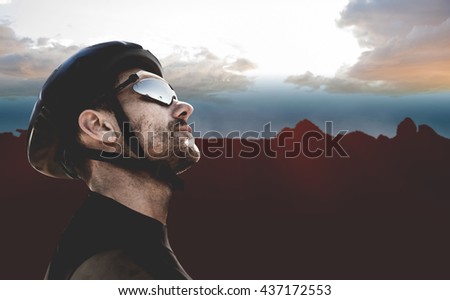 Man wearing a helmet against composite image of landscape