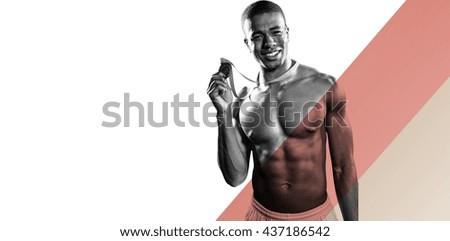 Sportsman holding gold medal against different colors