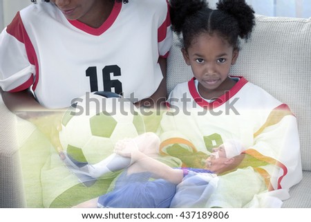 Composite image of cute girl watching sport on television with her mother at home