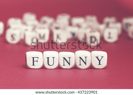 Funny word written on wood cube with red background