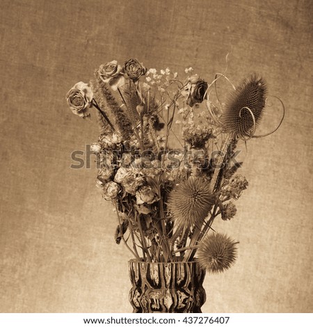 Bouquet of dry flowers on burlap background. Selective focus. Toned.
