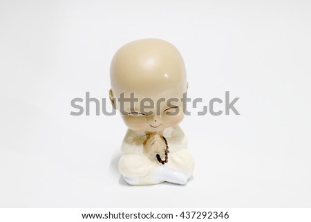 chinese ceramic young monk doll isolate on white background.
