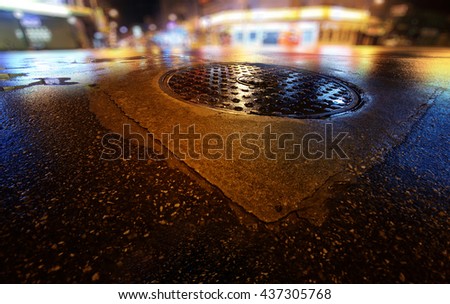 Night scene of wet road and blurry city. Rainy night in the city.
