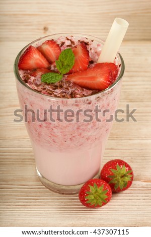 strawberry milkshake on a wooden background