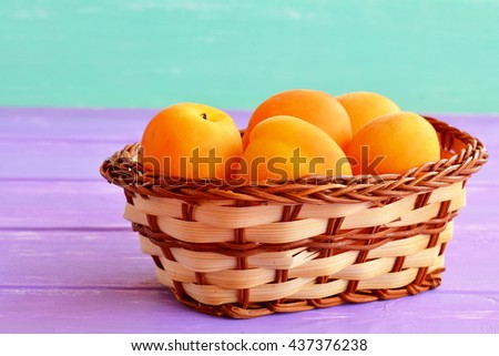 Sweet fresh apricots in basket. Organic orange fruits full of beta-carotene and fiber. Source of vitamins and minerals. Natural healthy vegetarian food, dessert. Stone fruits.