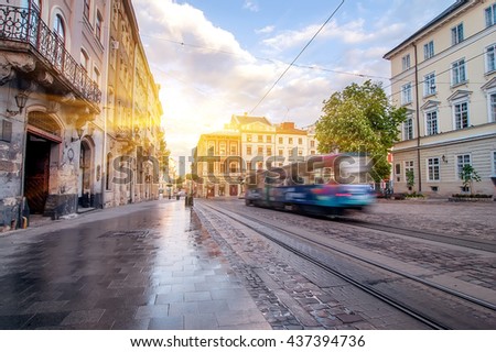 Blue tram rides on the morning  old european city.vintage picture