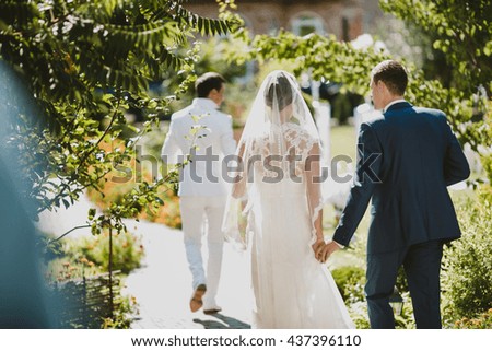 young couple walking in green garden
