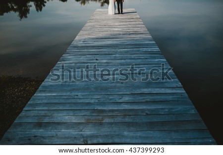 couple walking near a big beautiful lake
