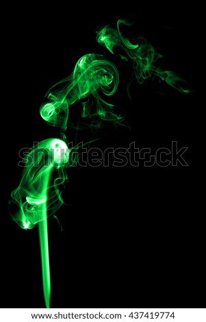 Abstract green smoke on black background from the incense sticks