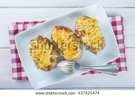 Twice baked potatoes stuffed with meat, jam, cheese and egg Royalty-Free Stock Photo #437425474