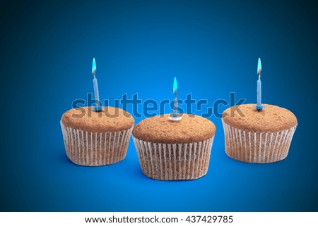 Three cupcakes on a wooden table