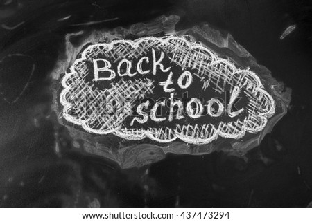Back to school background with title "Back to school"  written by white chalk on the black chalkboard