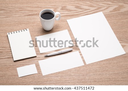Mockup business brand template on desk. Set of stationery with a black notepad.
