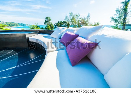 Beautiful luxury outdoor patio decoration with sofa and pillow on sea and ocean with blue sky background