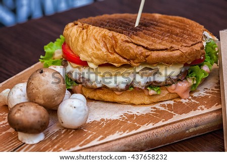 Delicious Hamburger And Mushroms On Wooden Plate