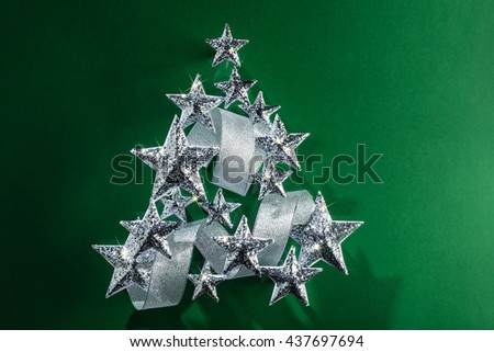 Silver sparkling Stars and Silver Ribbon over plain background