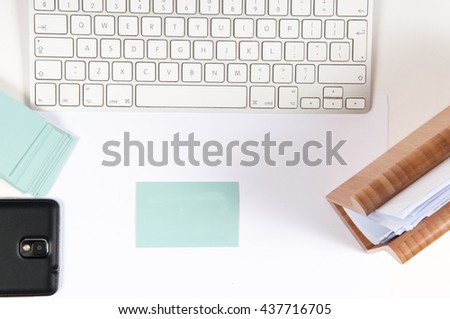 Business desk template with keyboard and blank business cards for small business or home office, viewed overhead