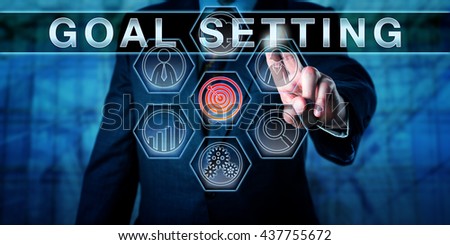 Human resources manager touching GOAL SETTING on an interactive virtual control screen. Business metaphor and personal development concept for a motivational process aimed at improving performance.