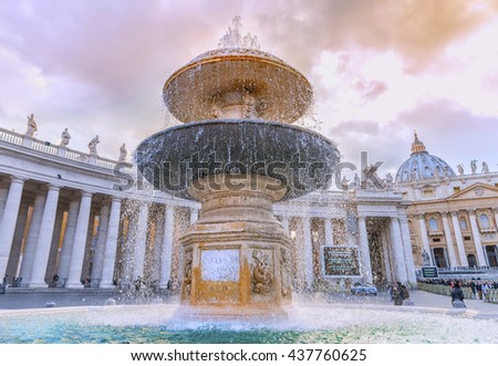 Beautiful fountain on the Saint Peter Square (Piazza San Pietro) at sunset against colonnade of the Saint Peter Basilica. Designed by famous sculptor Gian Lorenzo Bernini. Vatican. Rome. Italy.Europe. Royalty-Free Stock Photo #437760625