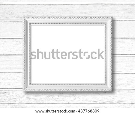 White blank picture frame on wood wall.